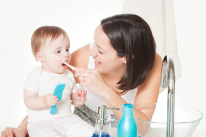 Mom Brushing Baby Teeth